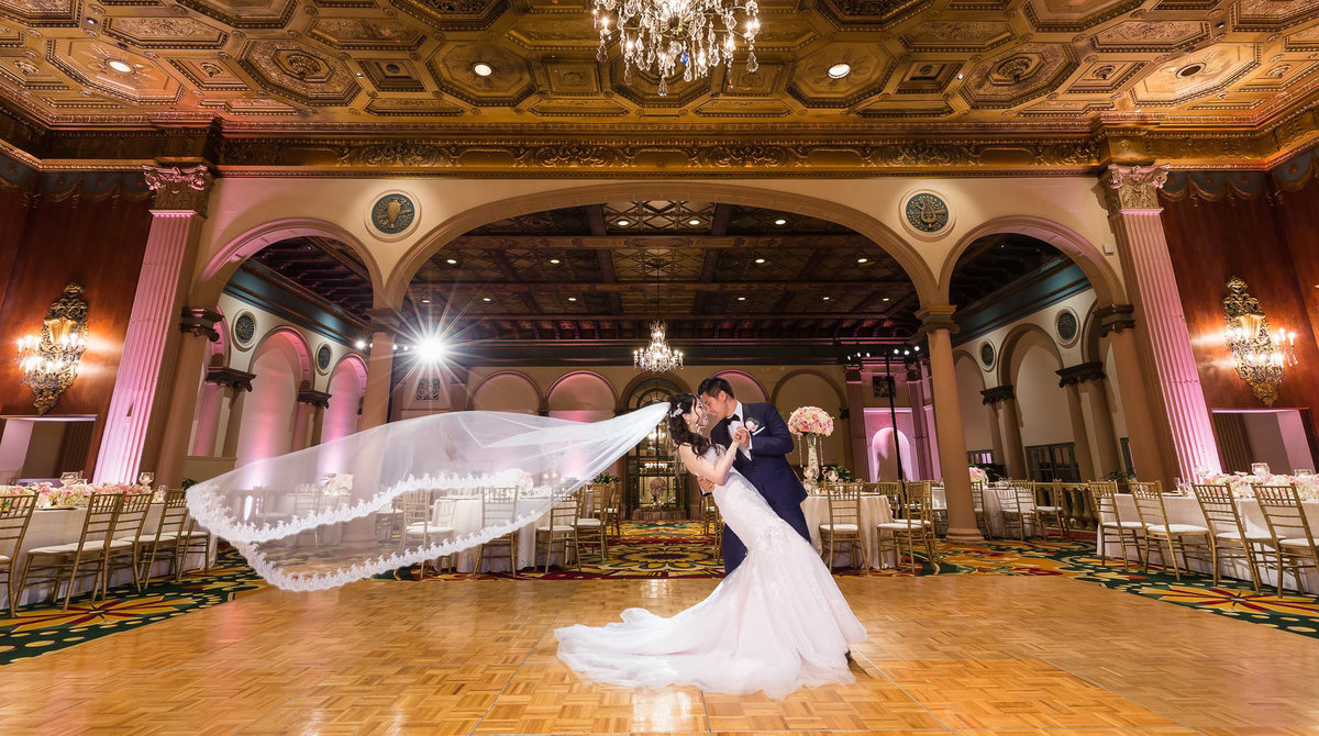 Best Dallas wedding photographer with couple in grand ballroom