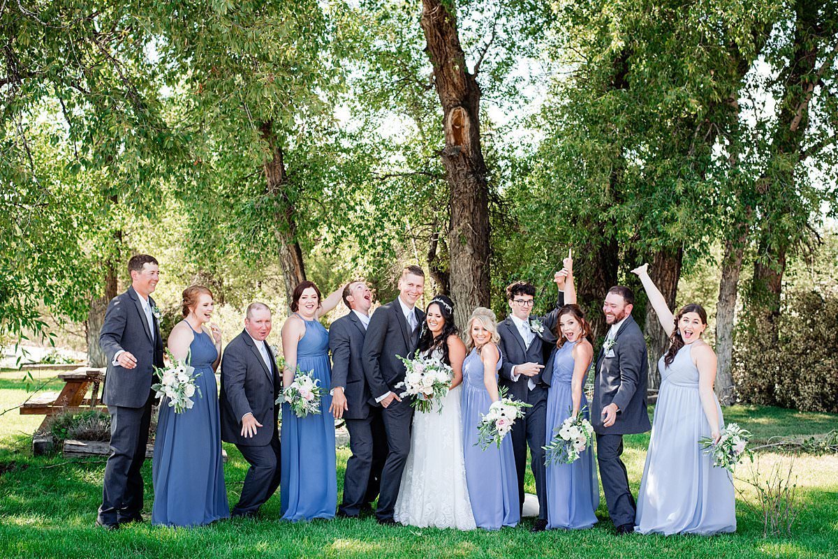 Bride and Groom celebrating alongside their wedding party on a summer day in Montana