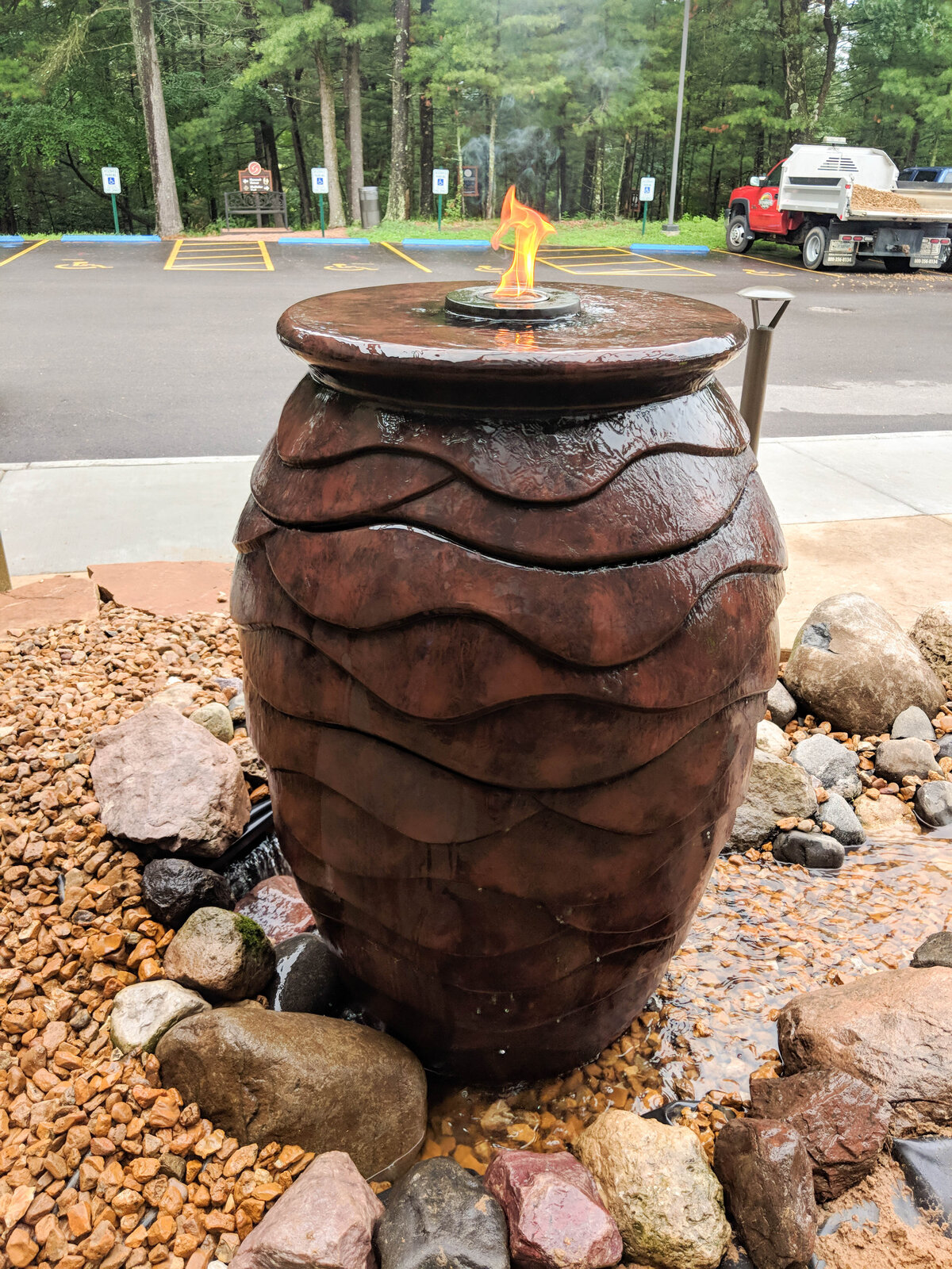 Urn water fountain with flame lit on top