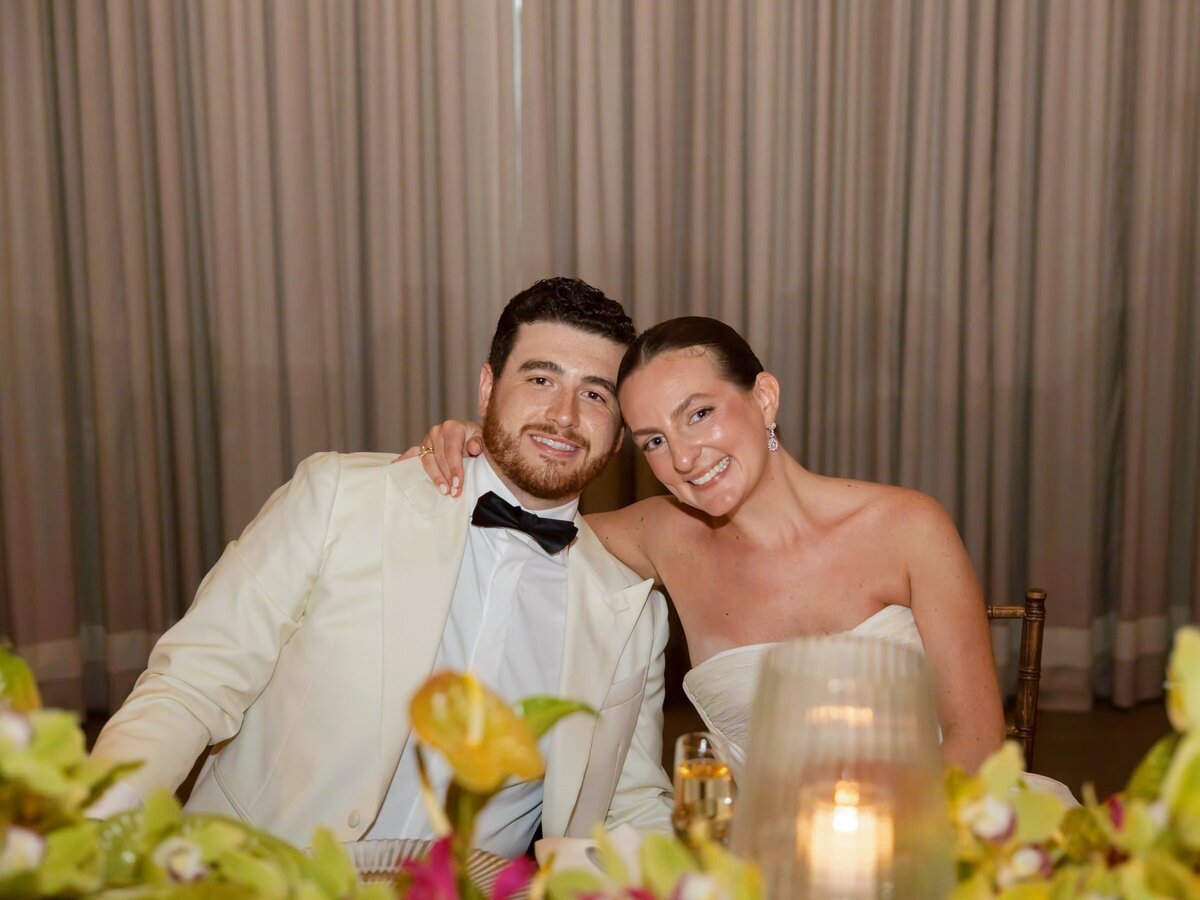 Kara and Nick laughing together at their sweetheart table