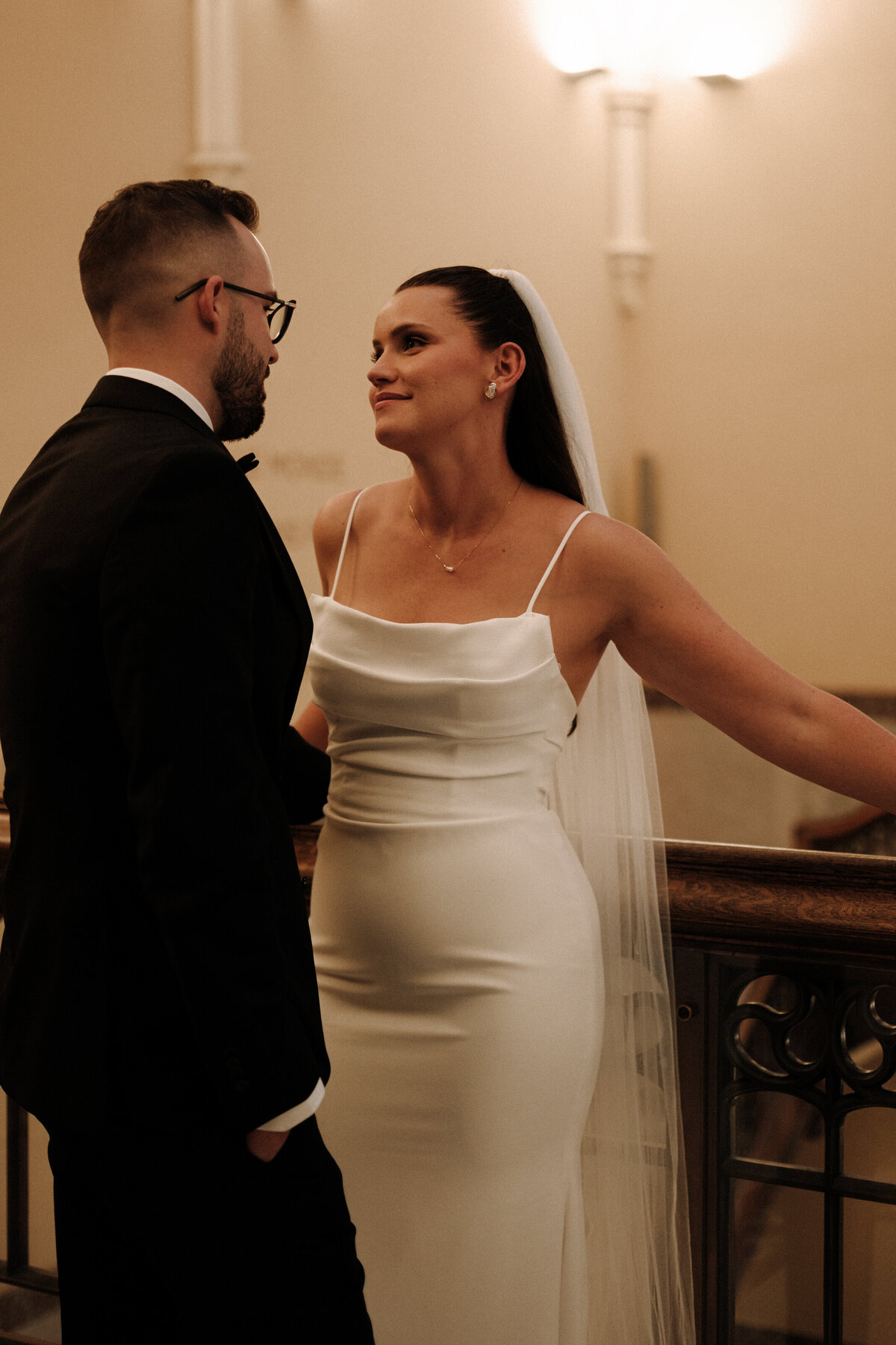 bride looks lovingly at groom in the romance of the musem