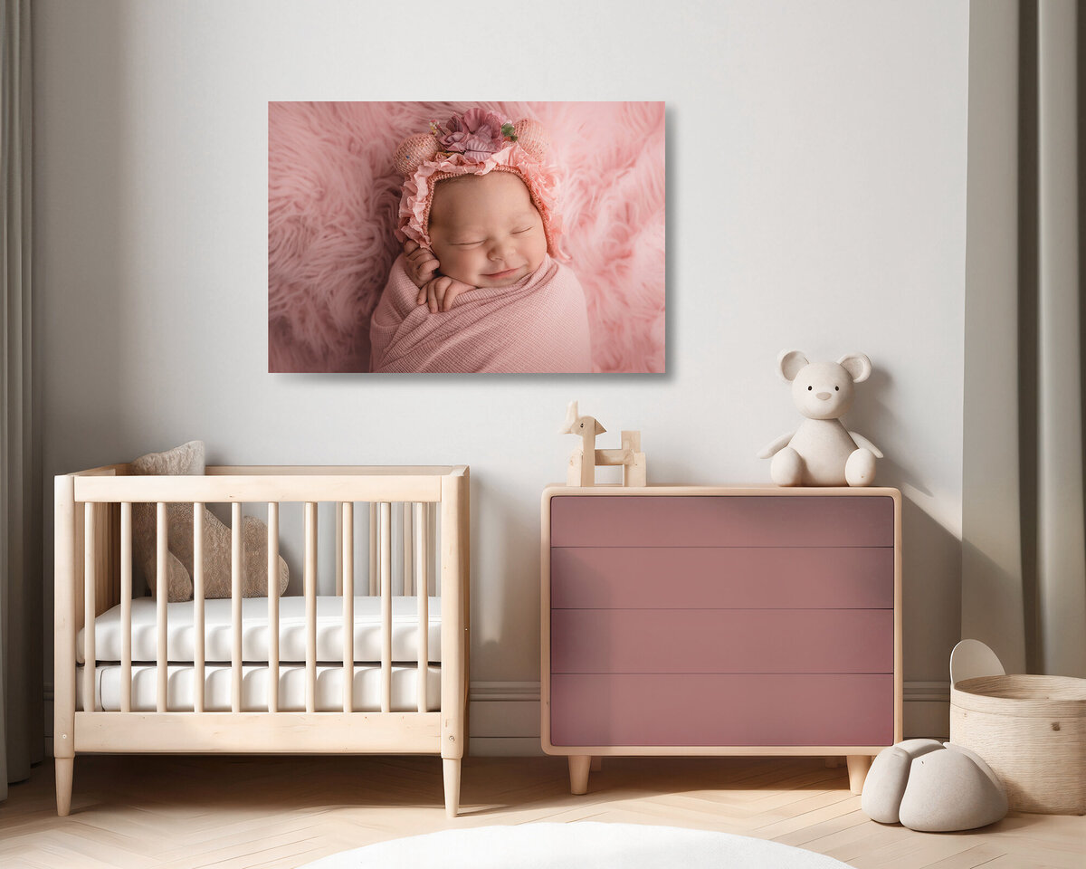 A portrait of a sleeping newborn above a crib in nursery