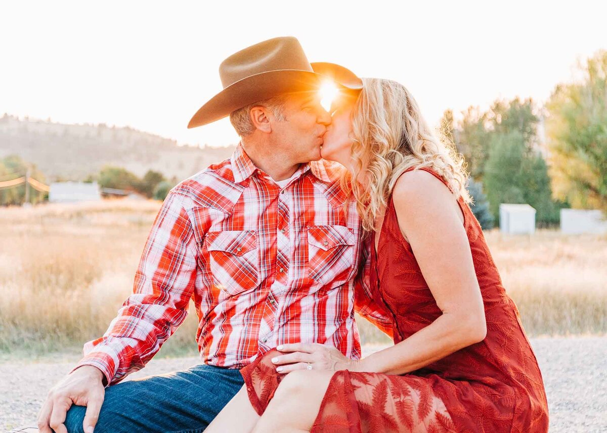 Montana engagement photo couple kissing at golden hour, Travelers' Rest State Park, Lolo, MT