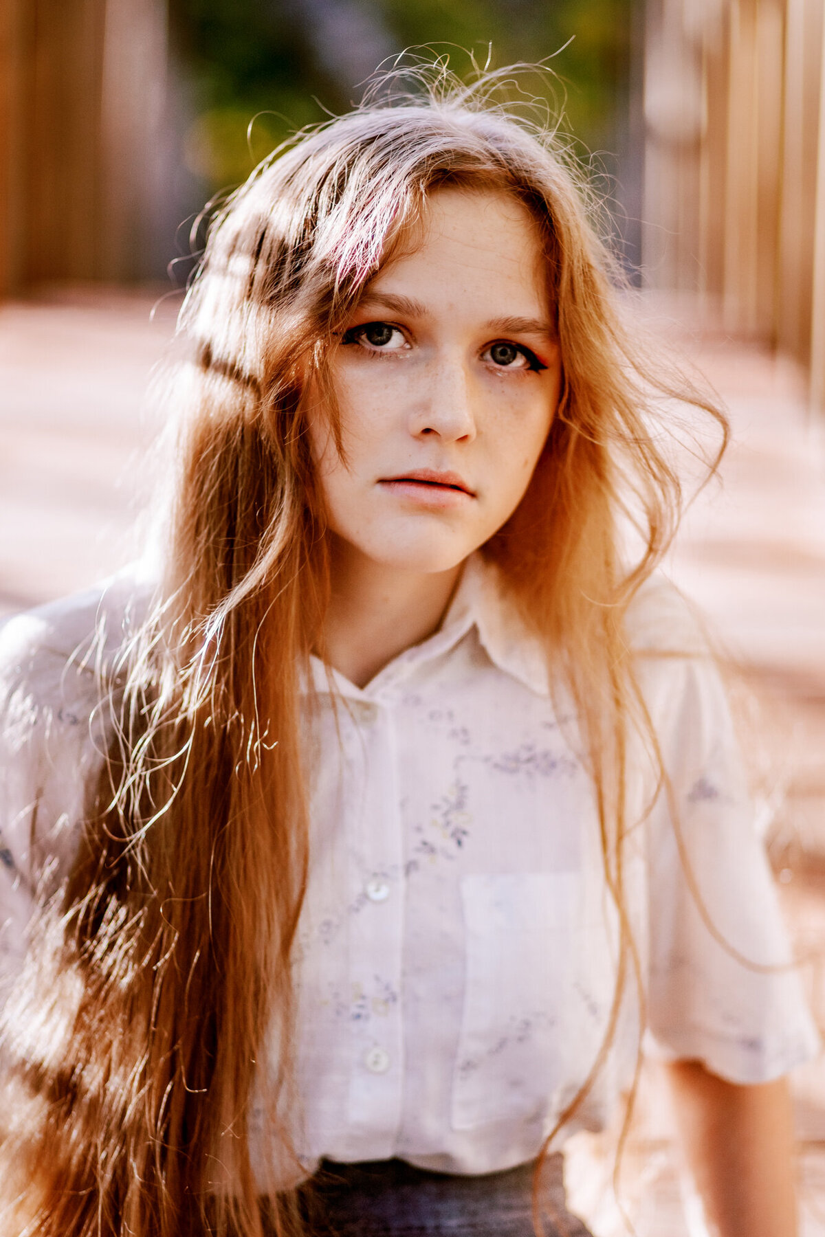 girl with long hair gazes at camera