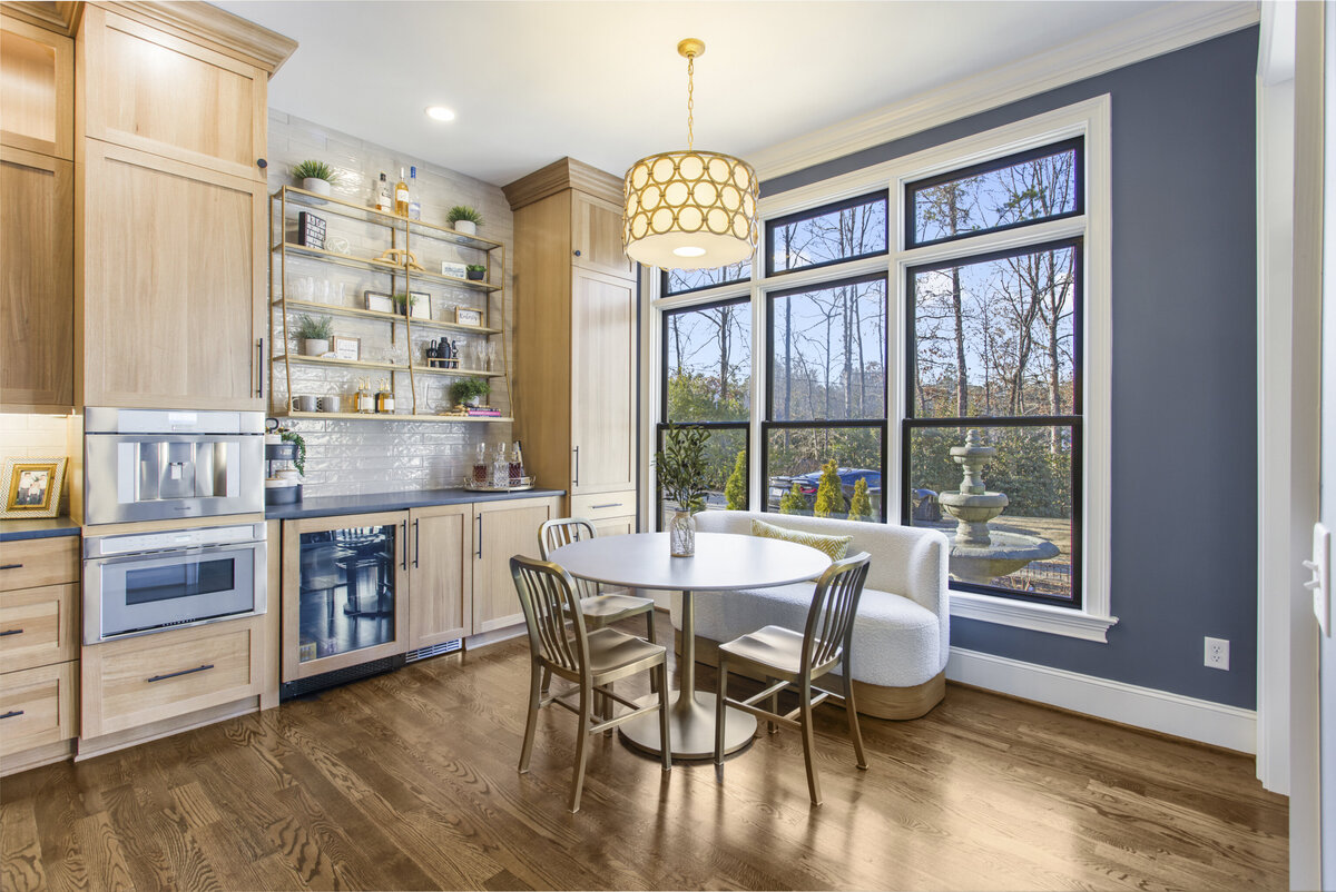 Breakfast table in front of a bar wall with large windows behind
