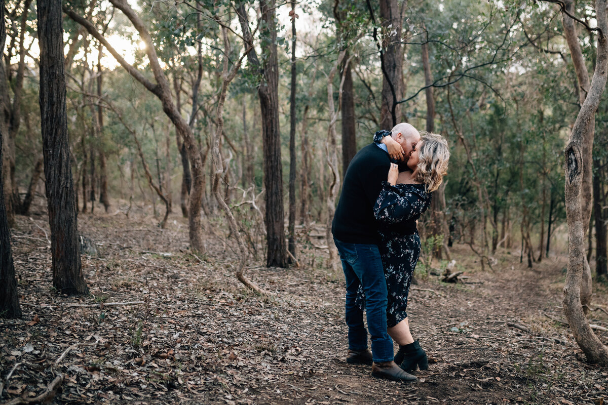 Man and woman embracing in bushland at sunset. Couples and engagement photography Melbourne, And So I Don’t Forget Photography