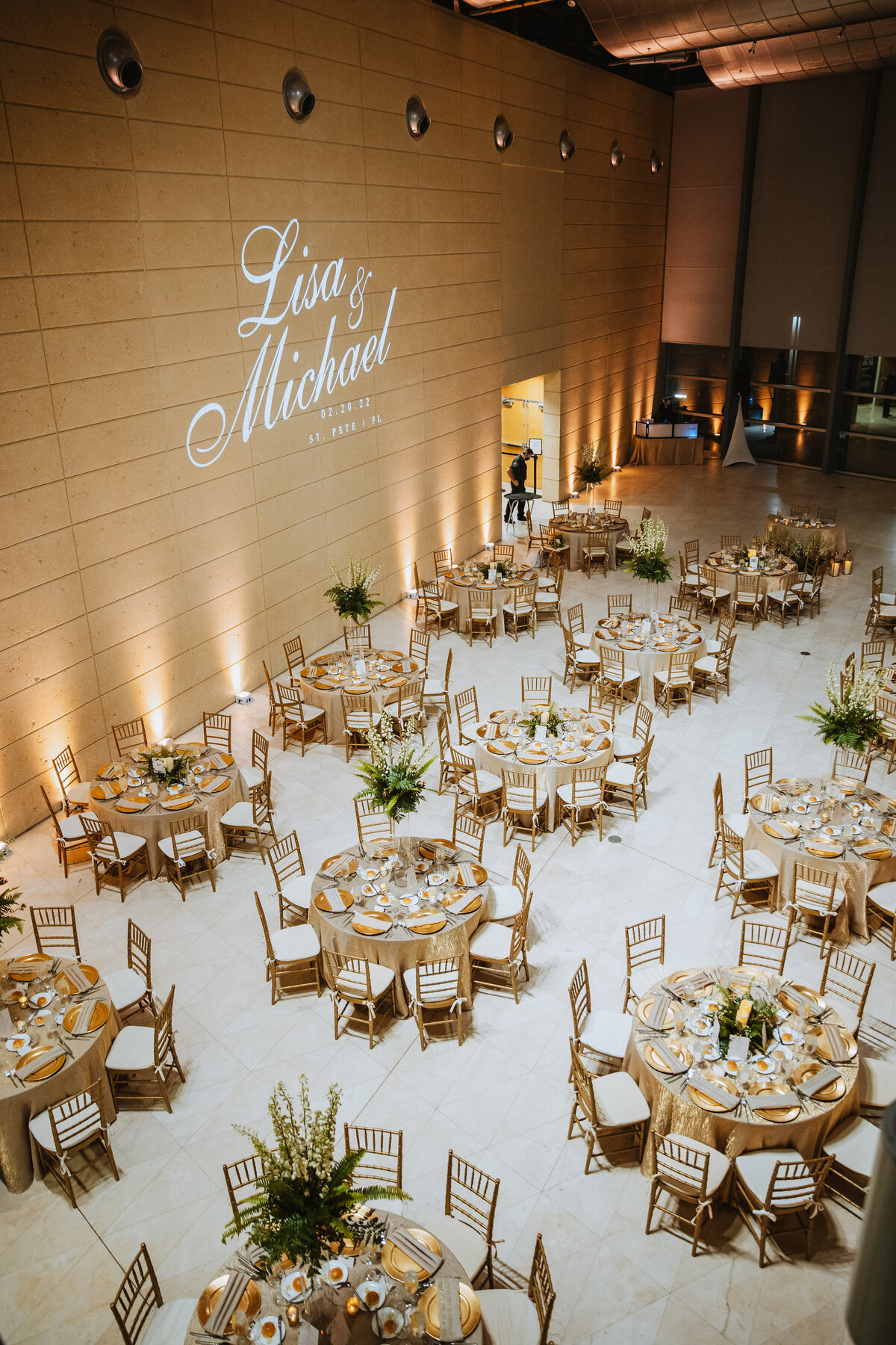 beautiful reception setup with tables chairs and centerpieces at the museum of fine arts in st pete florida