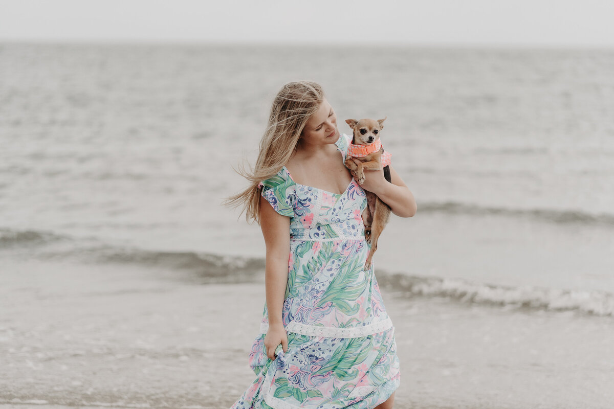 girl walking on the beach with dog