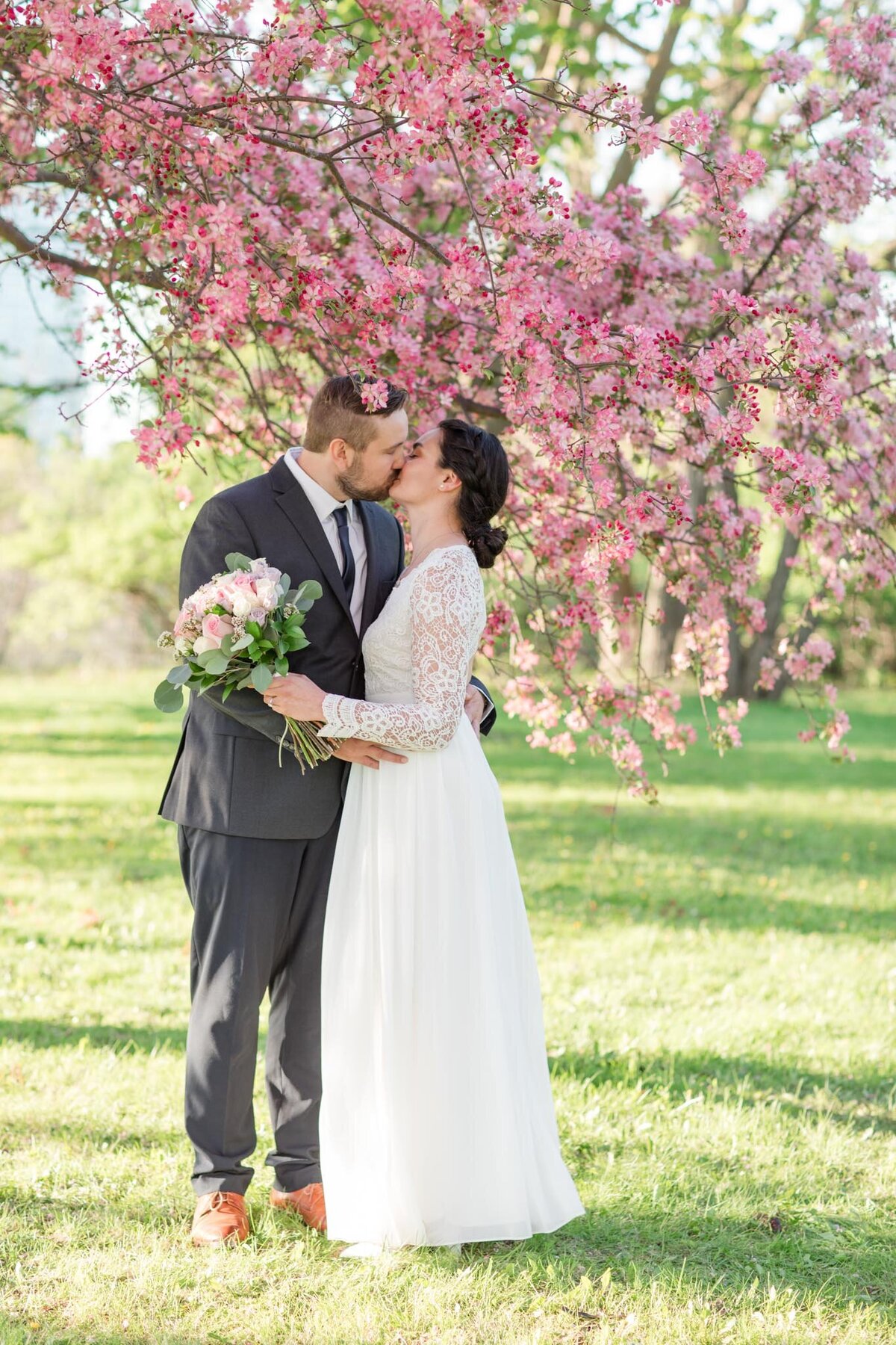 Immerse yourself in the romance as Taylor and David share a tender kiss beneath the blooming cherry blossoms, beautifully captured by Ottawa Wedding Photographer, Lauren Duffy. This captivating moment epitomizes the essence of love amidst nature's splendor. Lauren Duffy Photography preserves the magic of this intimate connection, ensuring the beauty of your love story is forever etched under the delicate embrace of Ottawa's cherry blossoms. Explore the artistry and passion that defines each frame, making your wedding memories truly unforgettable