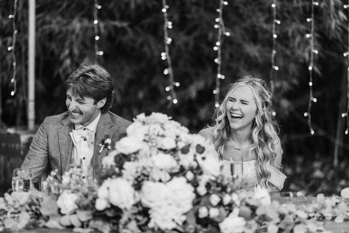 bride-and-groom-laugh-during-toasts