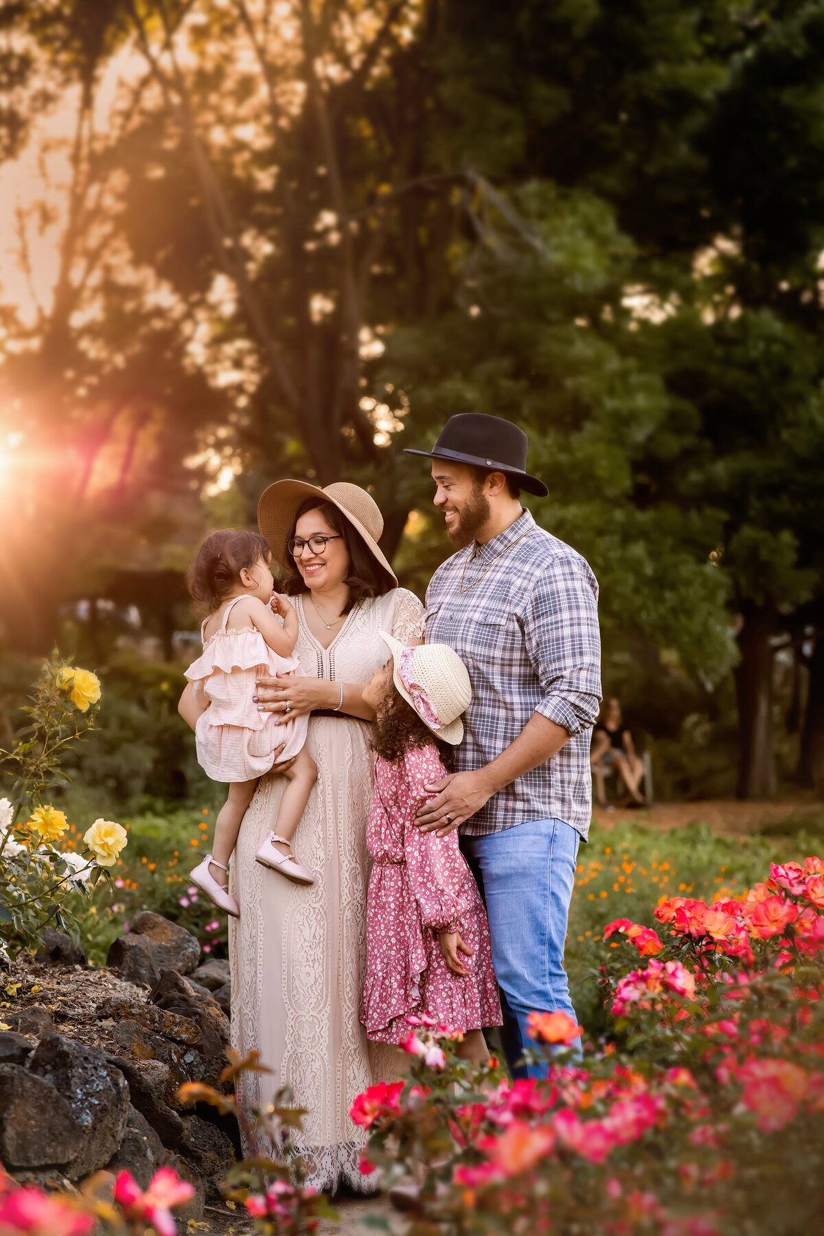 Family-of-four-enjoying-a-spring-day-in-rose-garden