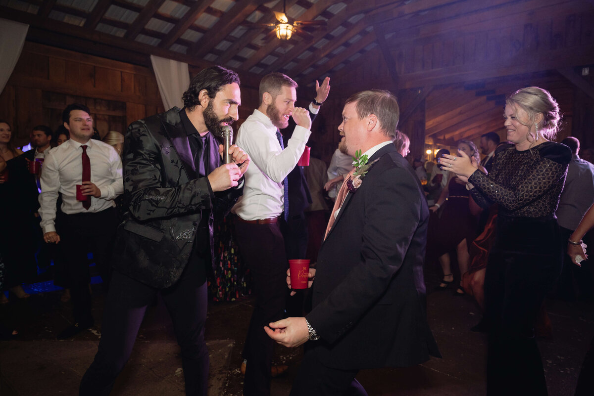 wedding guests dancing together in a barn at a Charlottesville wedding venue