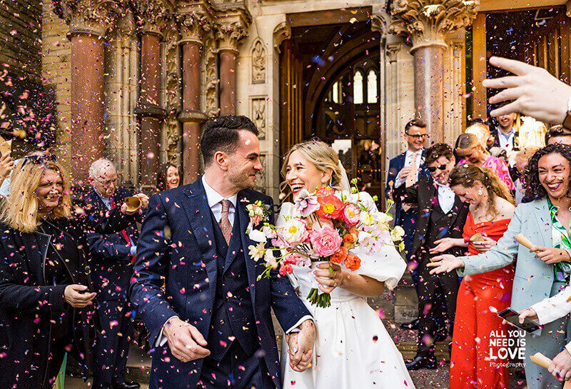 Bride and groom covered in confetti 298