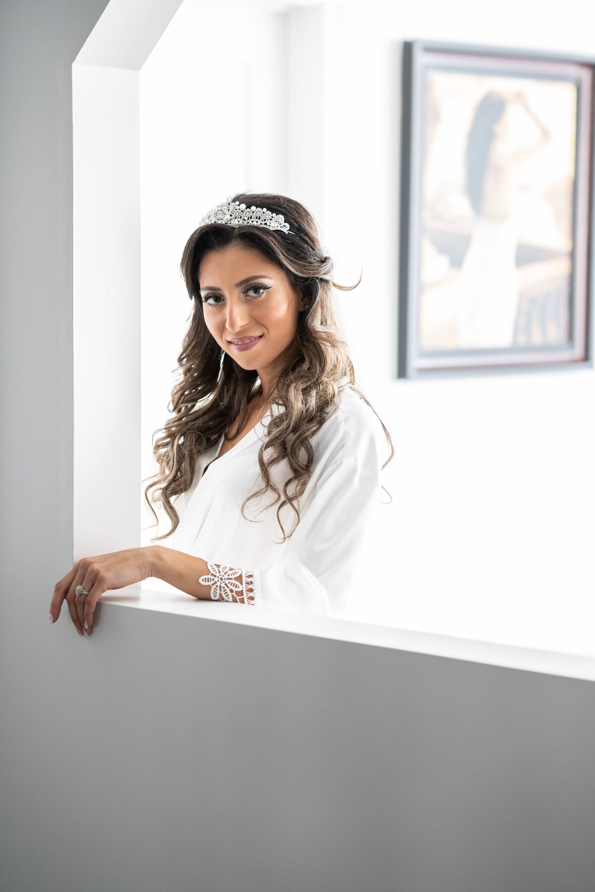 A beautiful bride smiles warmly, showcasing her radiant joy and elegant bridal look. This image captures the essence of bridal portraits, highlighting the genuine happiness and grace of the bride on her special day.