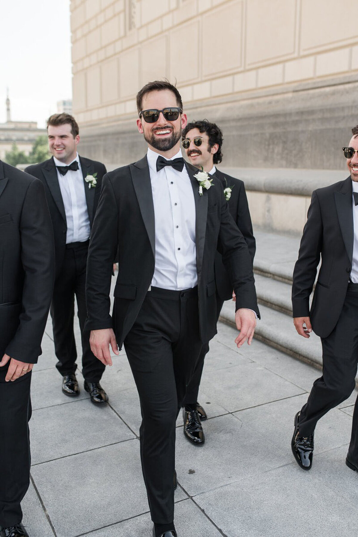 Groomsmen wearing sunglasses and walking, taken by one of the top wedding photographers in Cincinnati