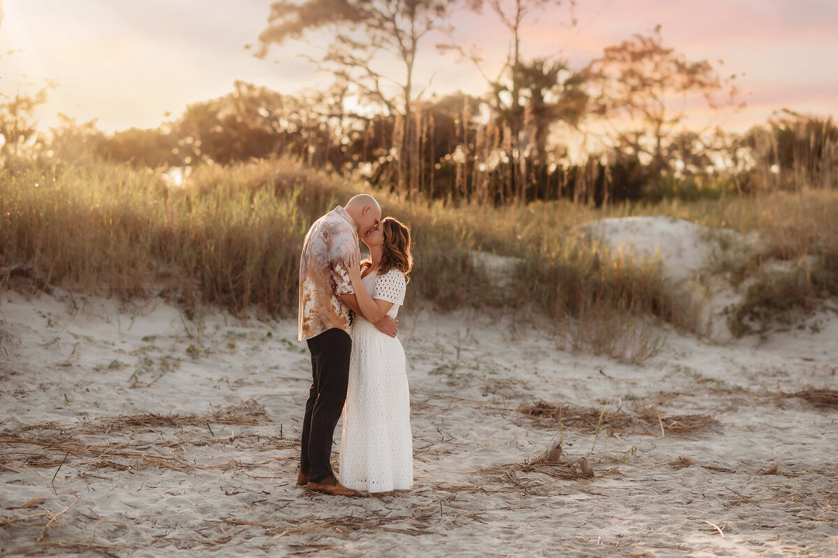 Couple kisses during Family Pictures on Folly Beach.