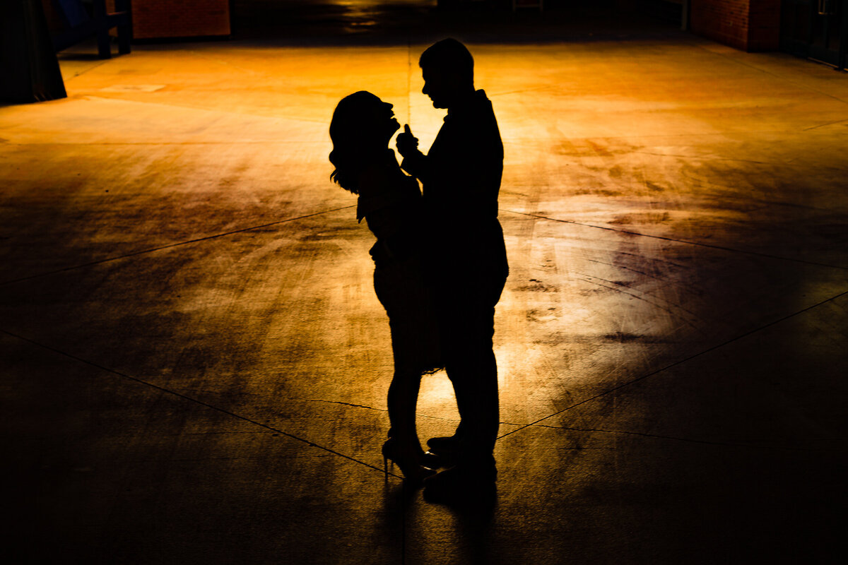 One of the top wedding photos of 2020. Taken by Adore Wedding Photography- Toledo, Ohio Wedding Photographers. This photo is a silhouette of a bride and groom embracing at Comerica Park in downtown Detroit Michigan