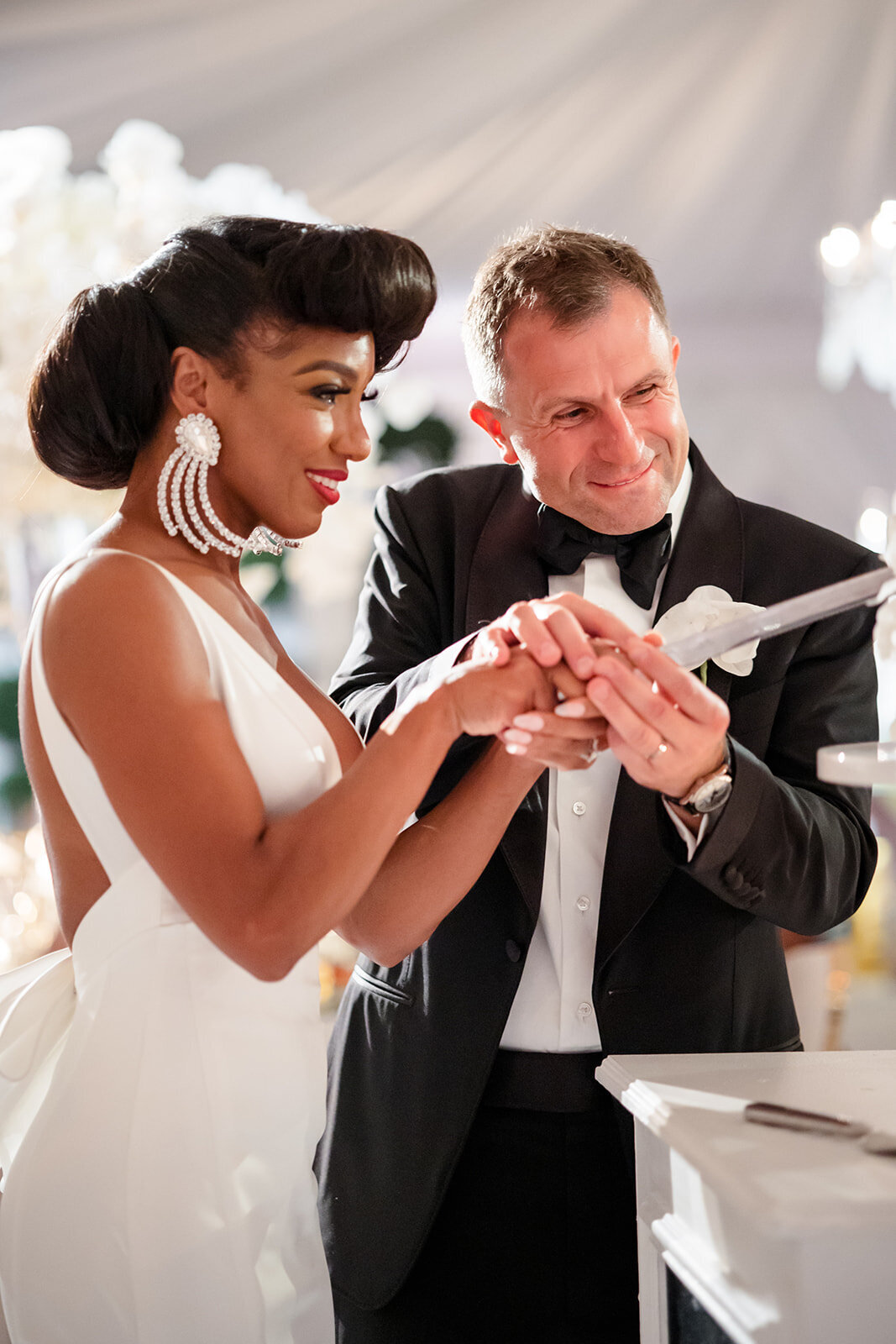Bride and groom cutting the cake.