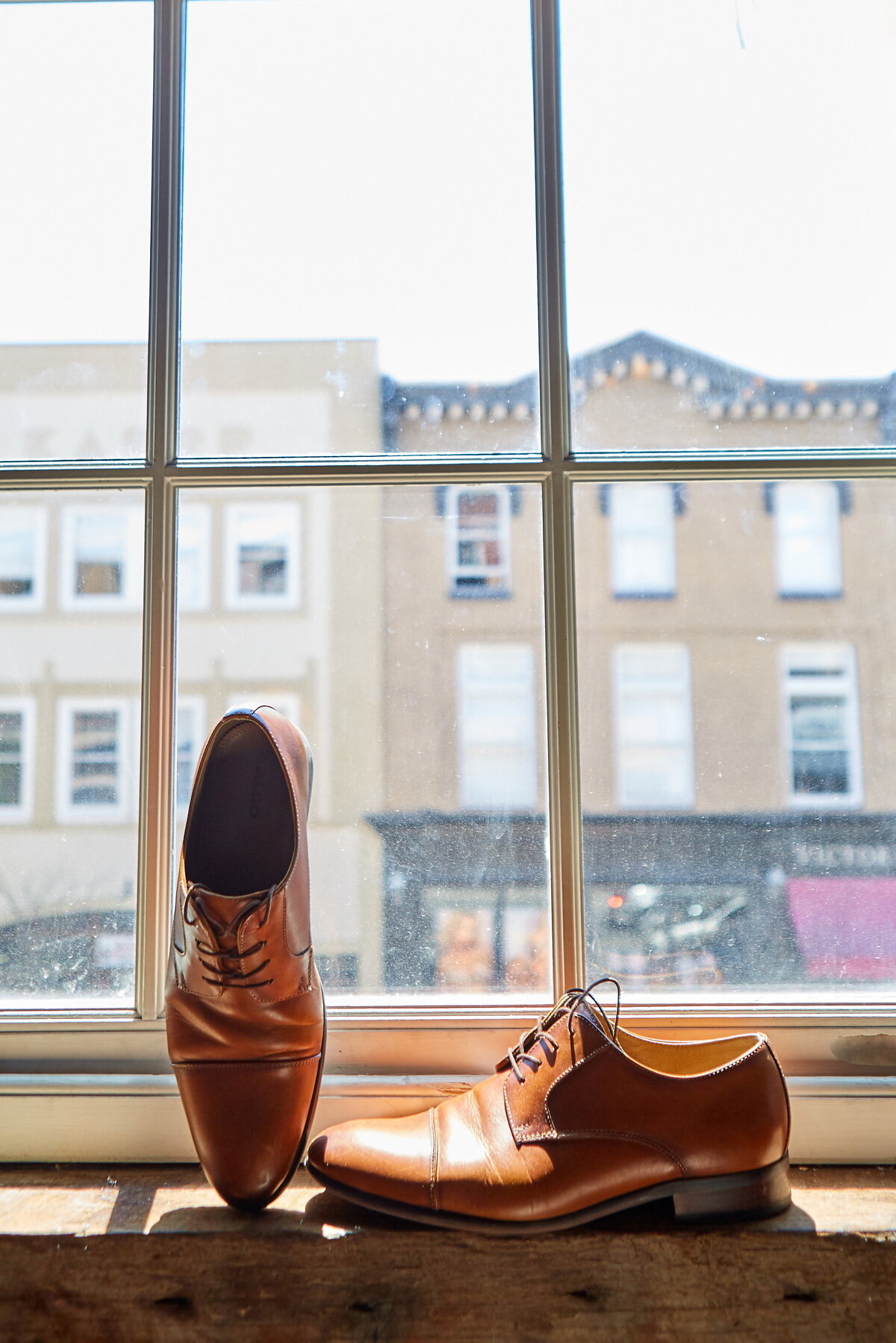 brown-groom-shoes-in-savannah-window