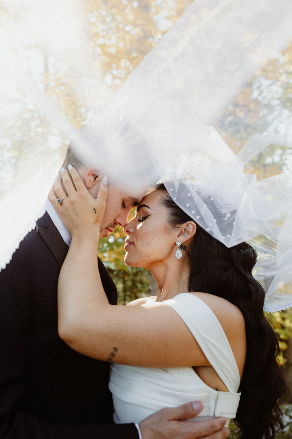 newlyweds sharing a moment under a veil