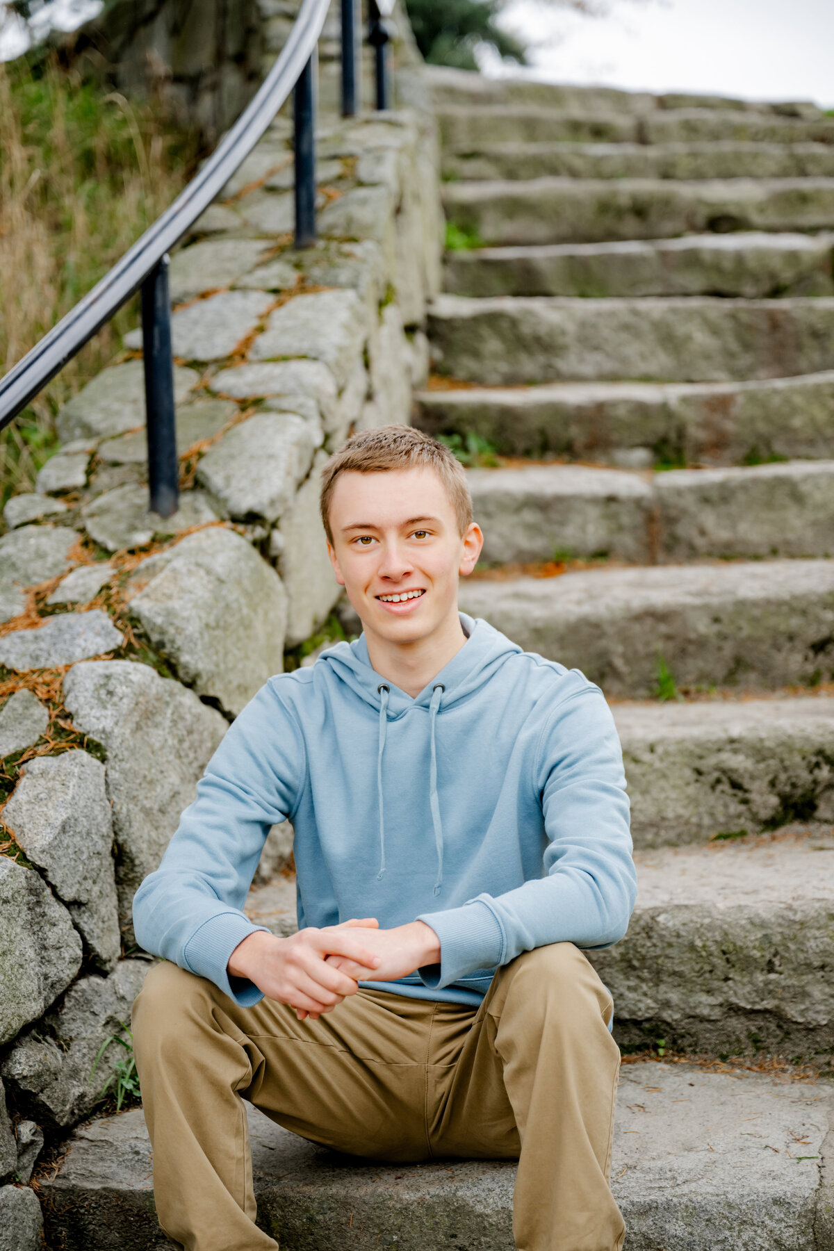 senior guy seated on rock steps