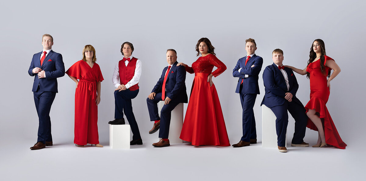 Dallas family photographer captures a stunning family portrait in red and blue outfits, exuding elegance and style.
