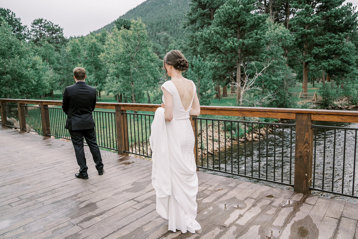 Bride and groom stand ready for their first look on their wedding day at the Landing in Estes Park.