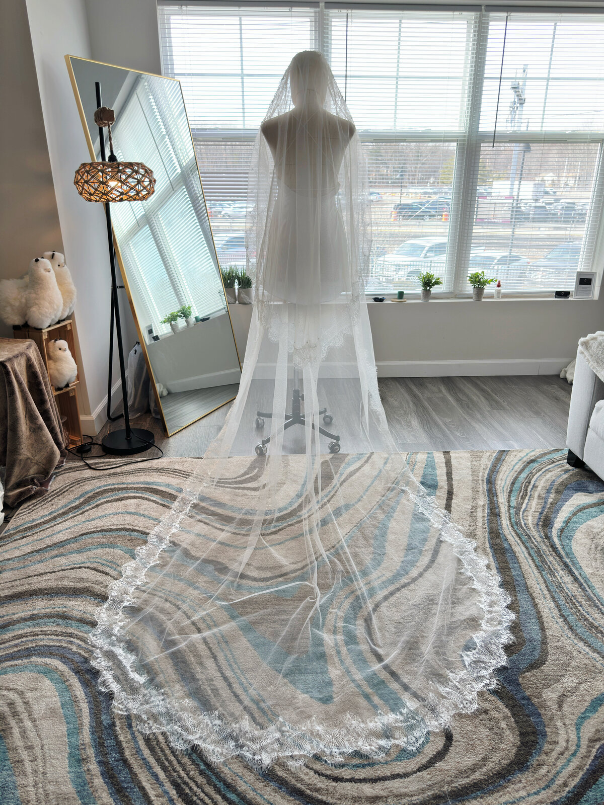 Bride wearing lace and pearl blusher veil with low bun
