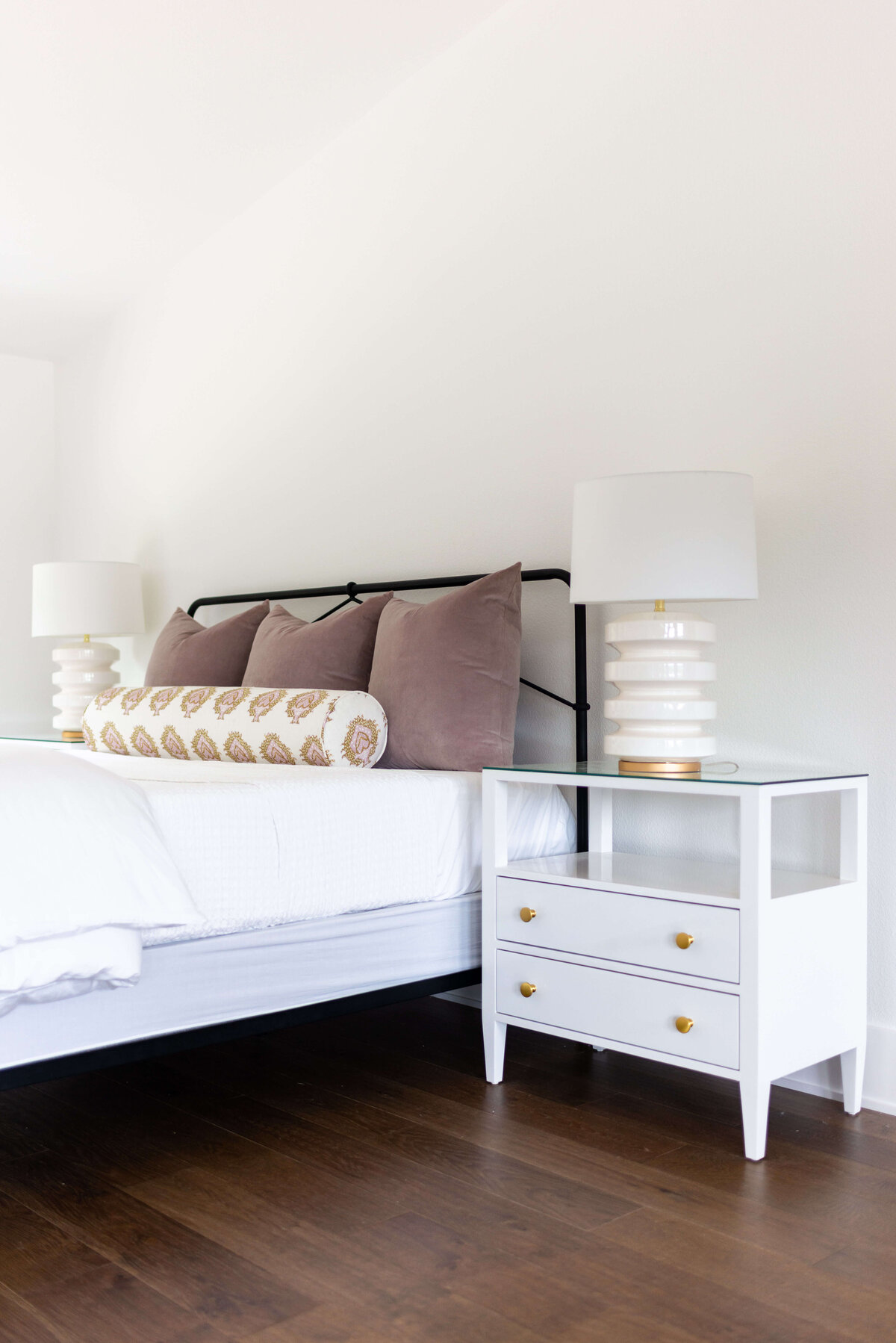 oyster creek studios building belt new build white bed with two white lamps and white bedside table in bedroom