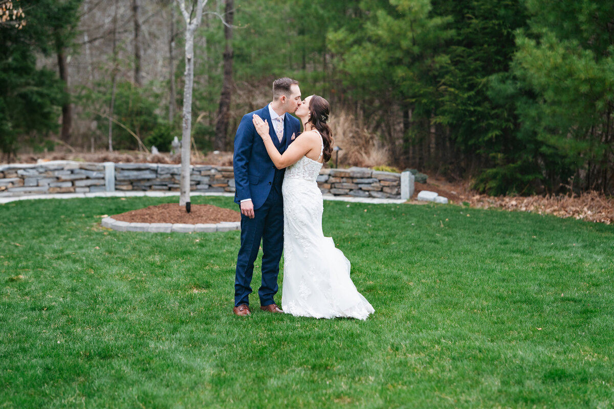 First look between bride and groom on a tree-lined path