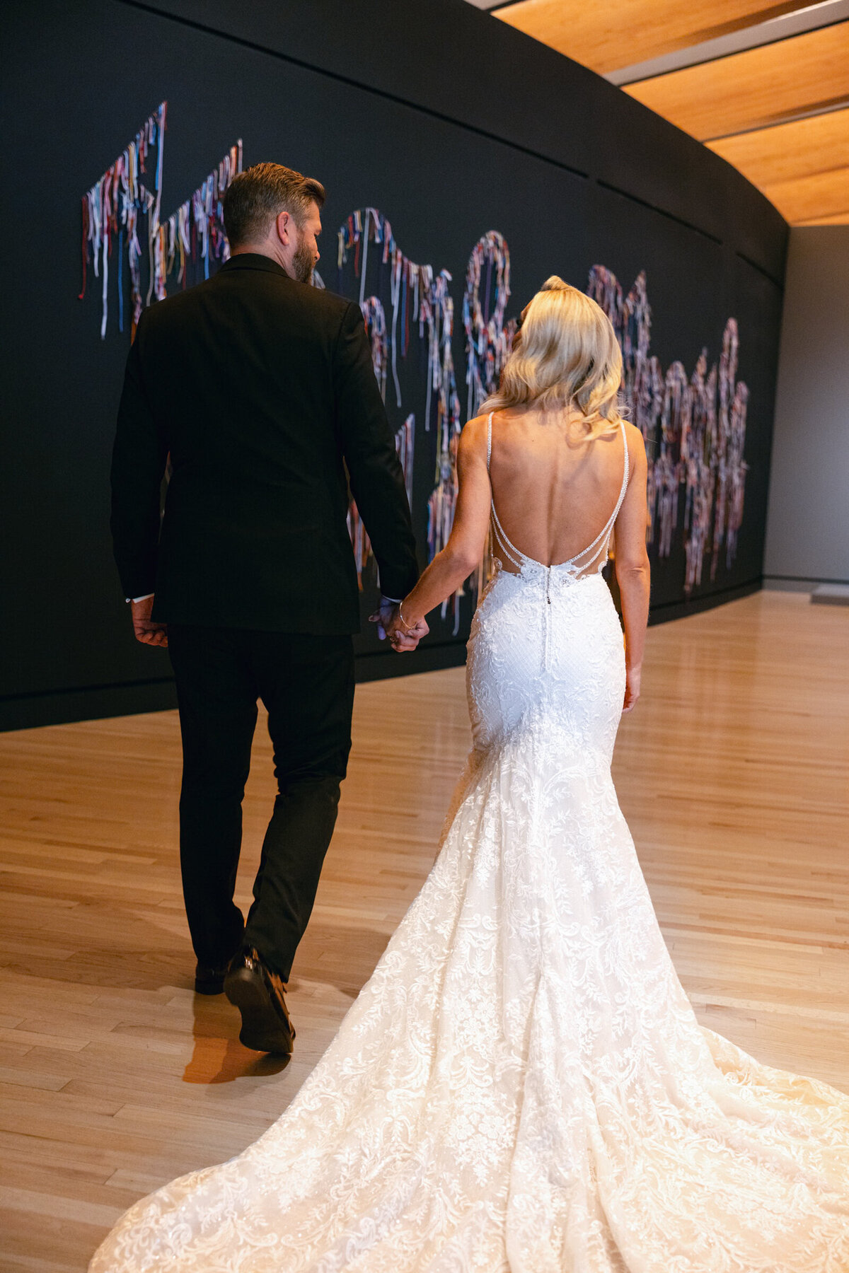 A wedding day photo of the bride & groom during their first look, at Crystal Bridges Museum of American  Art in Arkansas