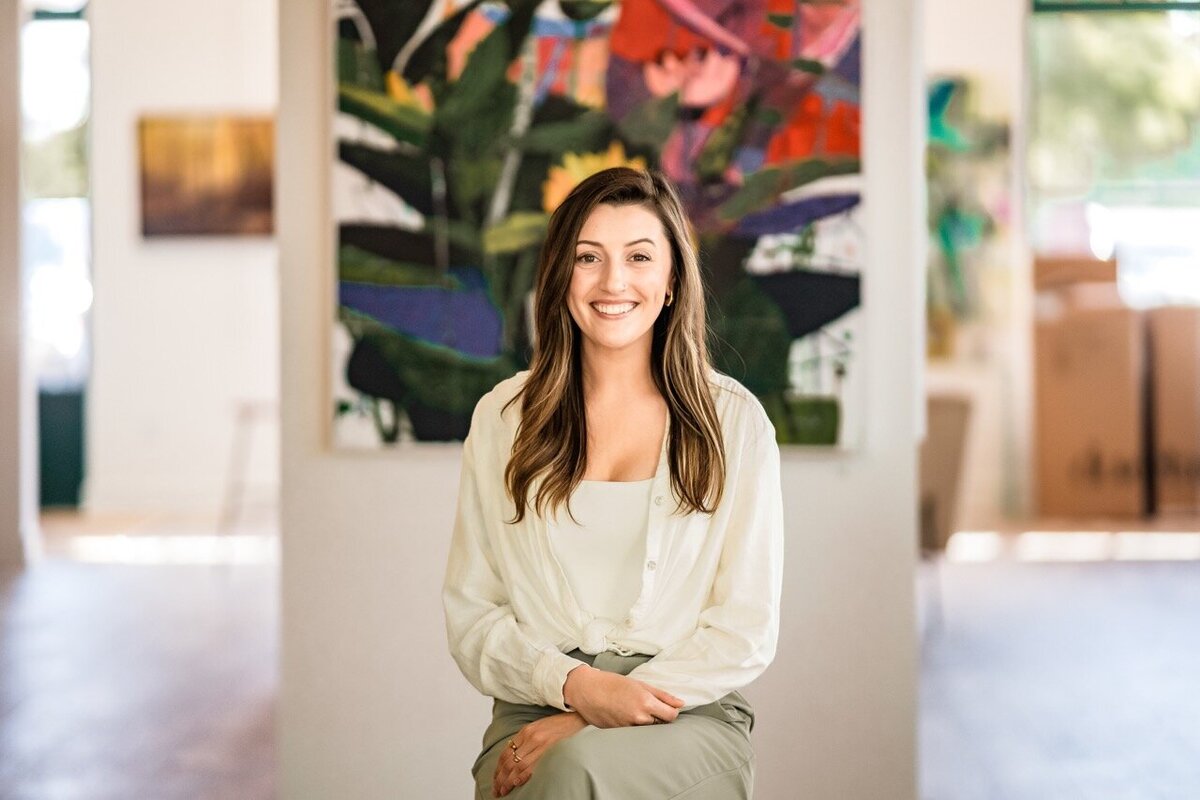 Young woman with a beautiful smile posing for a branding portrait session 