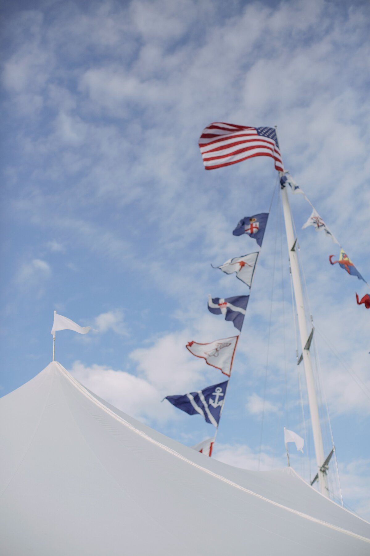 American Flag and sailing flags blow in the wind