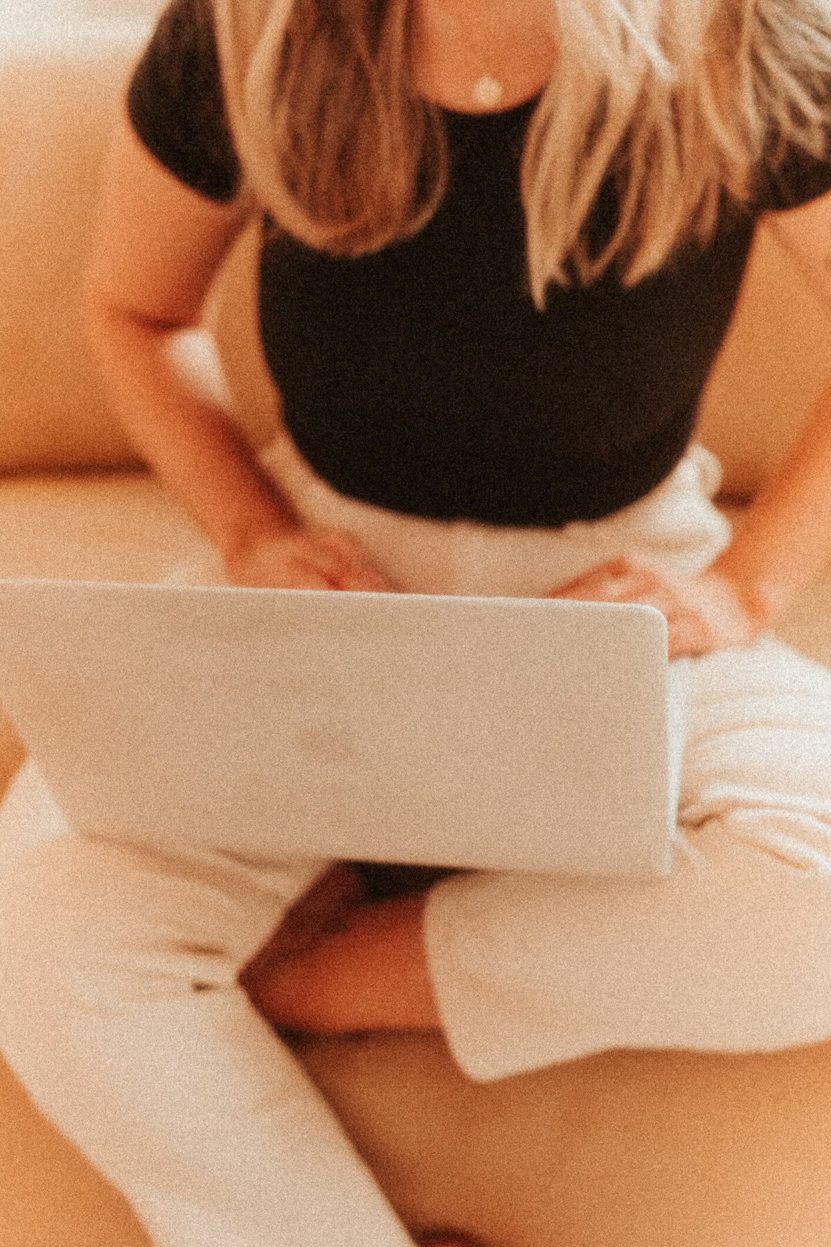 Girl sitting on couch and working on macbook