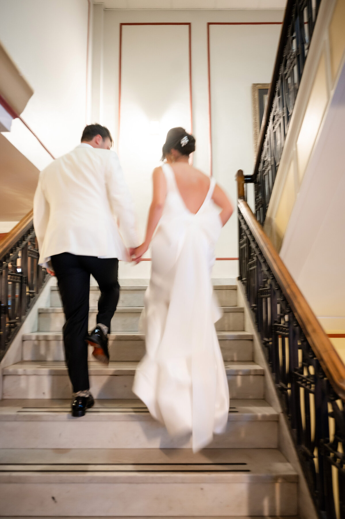 bride and groom candid wedding photograph on staircase inside of george washington hotel pennsylvania