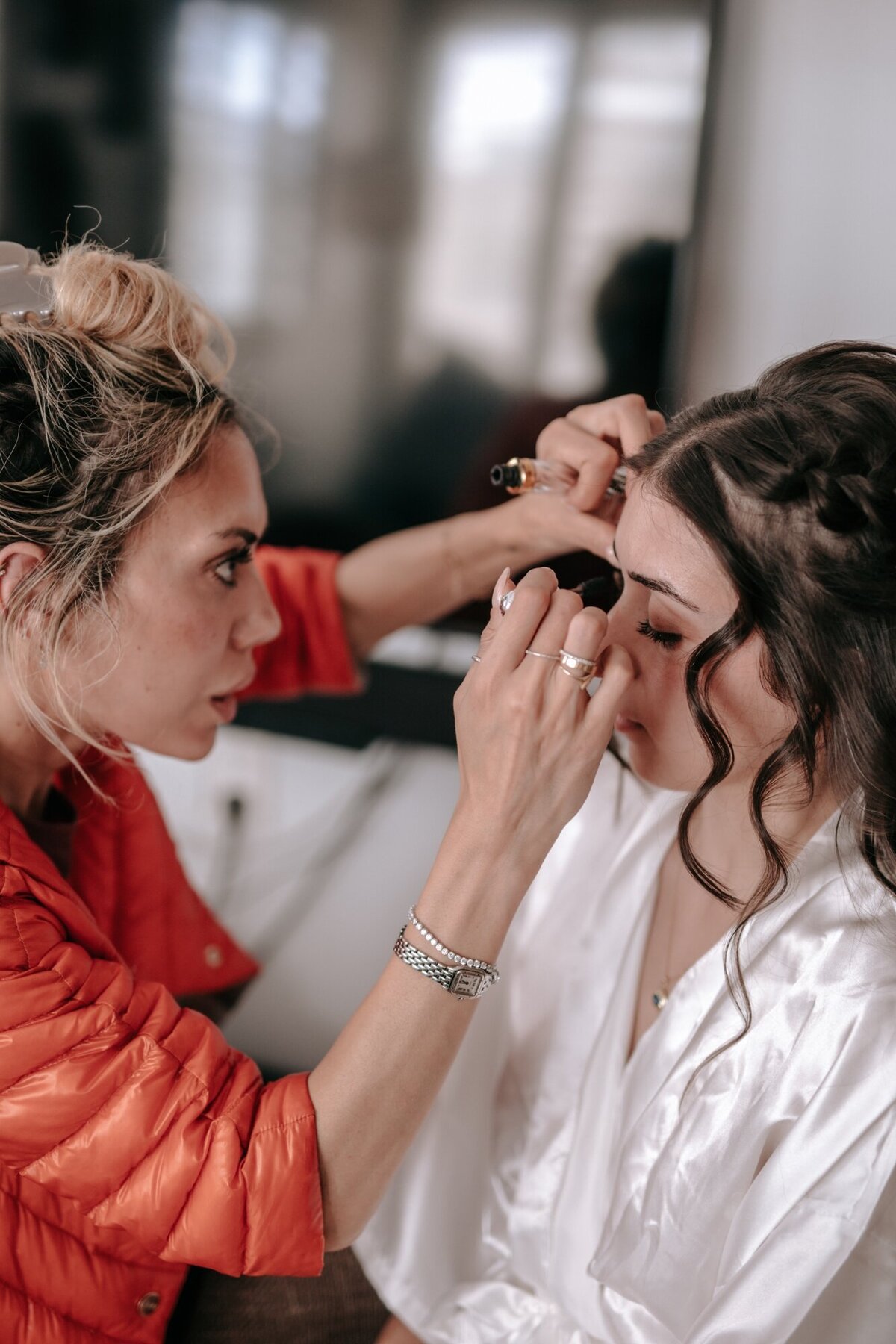 Makeup artist applying brides makeup.