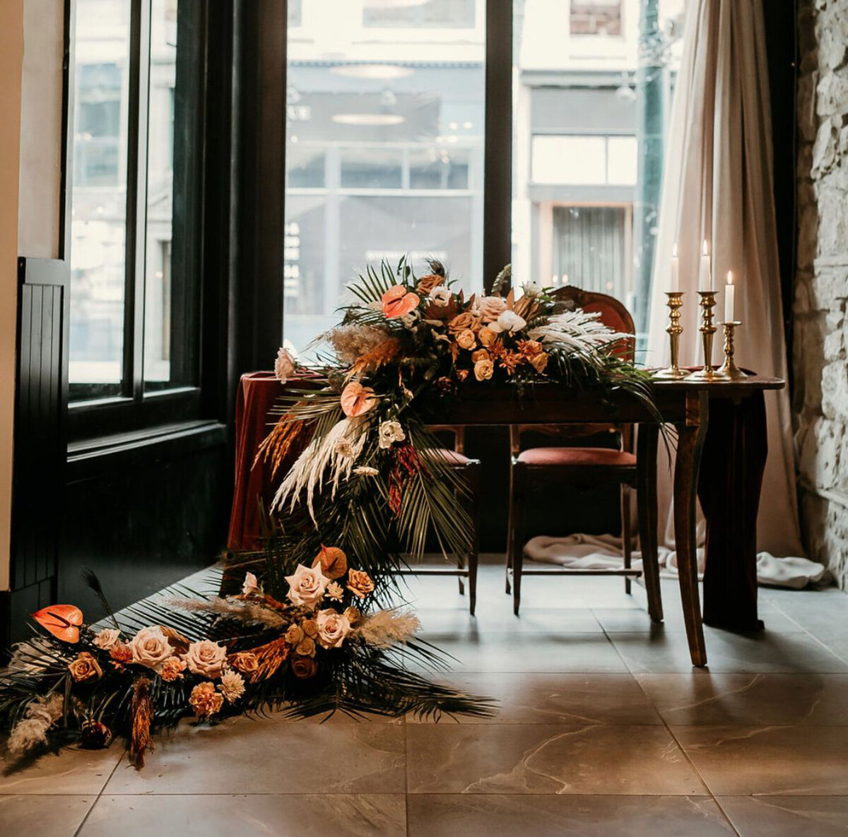 Moody and romantic floral installation by Hue Florals, artistic Calgary, Alberta wedding florist, featured on the Brontë Bride Vendor Guide.