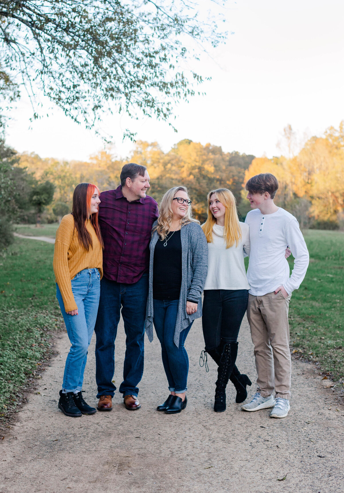 family with older siblings posing for photos at Fletcher Park in Cleveland, TN