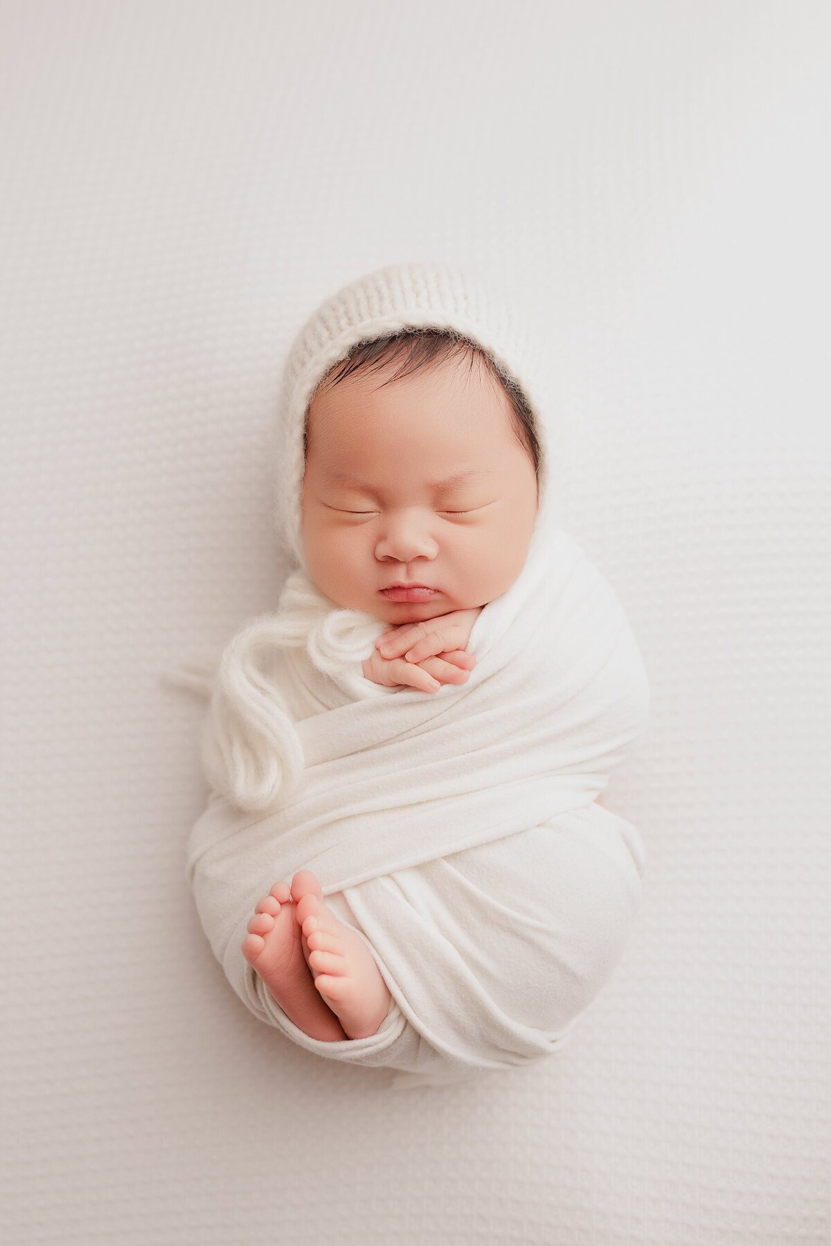 Beautiful newborn portraits in Elk Grove and Sacramento, capturing your baby's precious moments with simple elegance. Book your session today