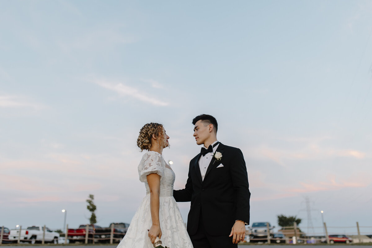 bride and groom sunset session with a pink and blue painted sky