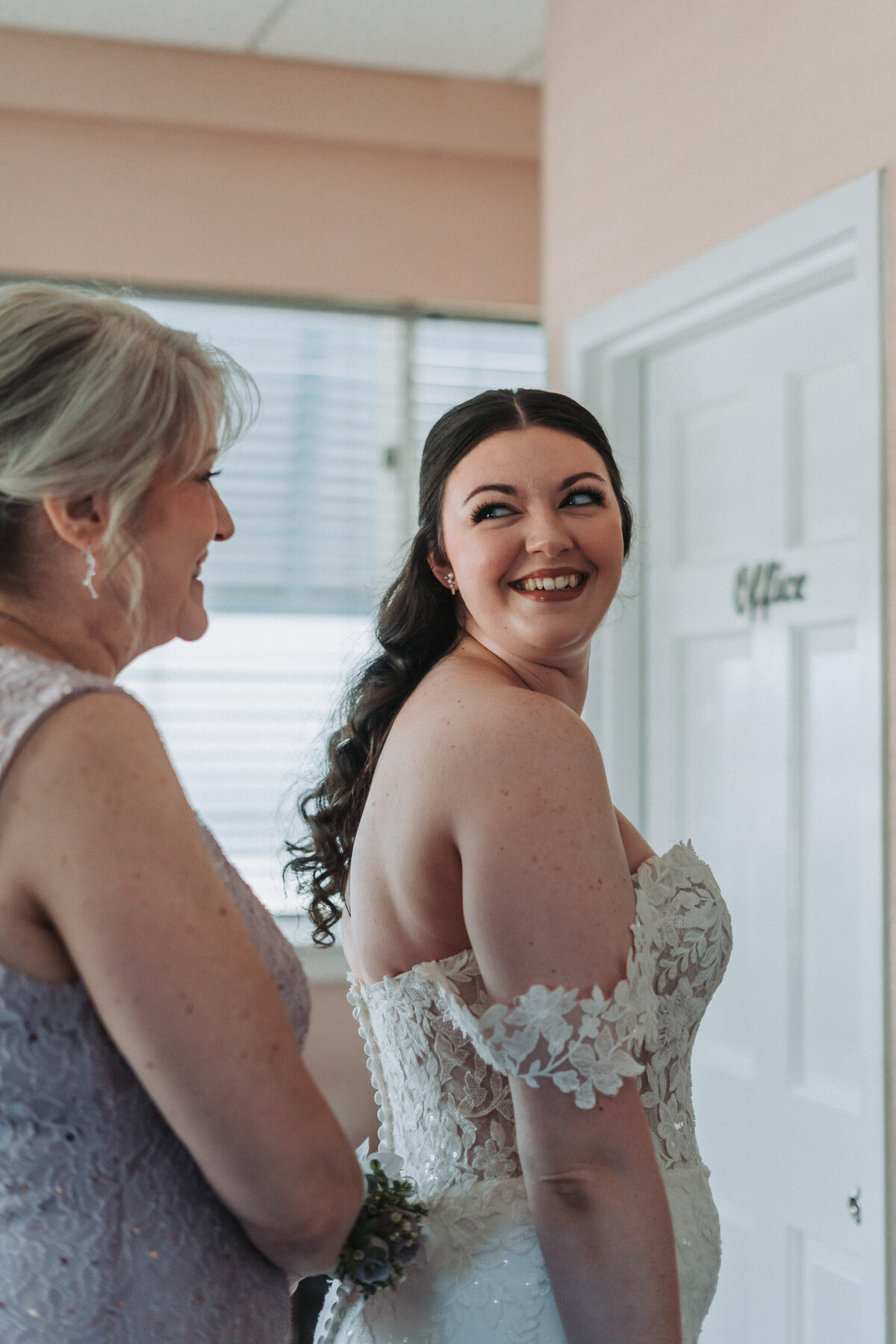 Bride shares a joyful smile with her mother while getting ready at Lesner Inn in Virginia Beach, Virginia.