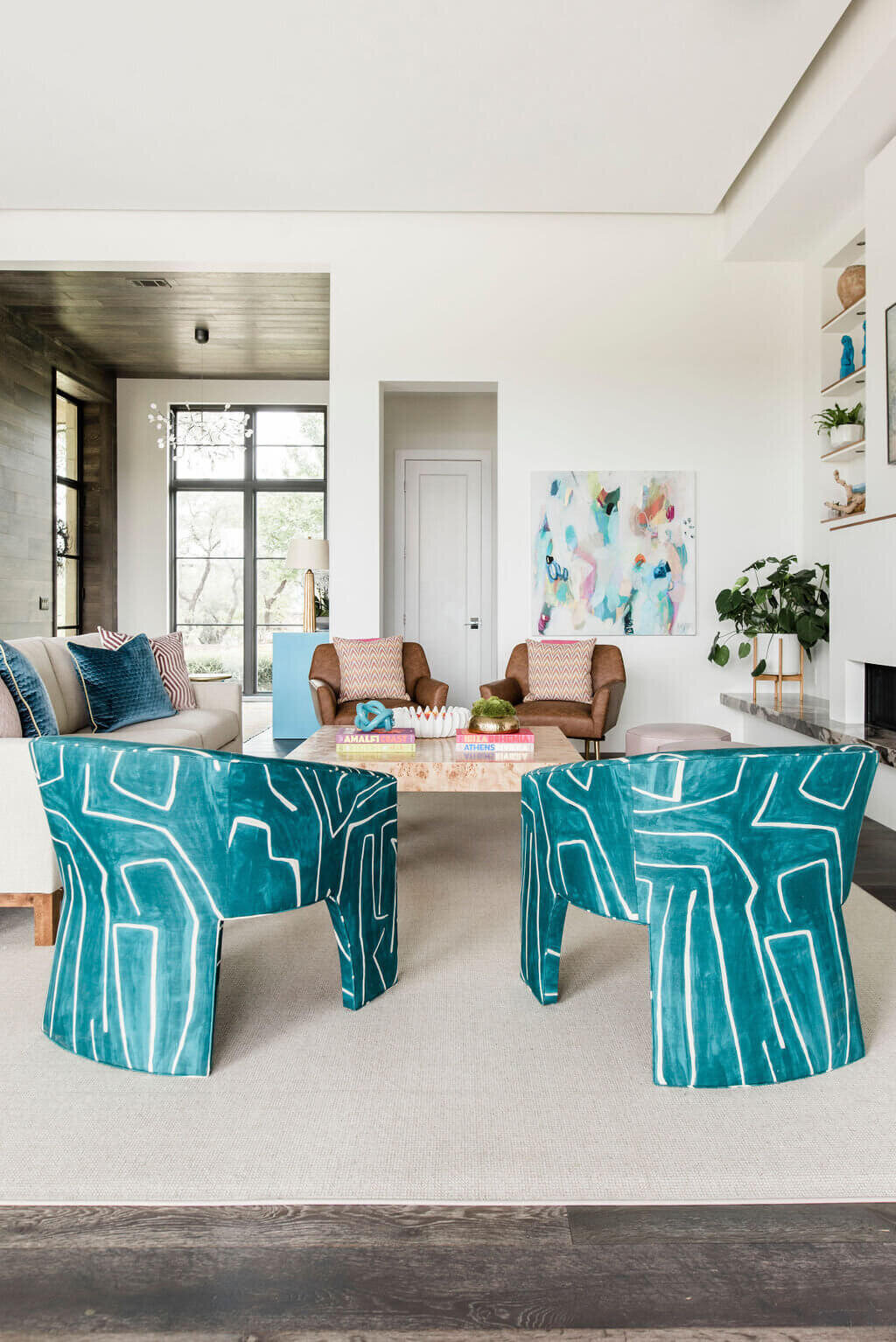 oyster creek studios austin barton creek turquoise chairs and brown leather chairs in living room