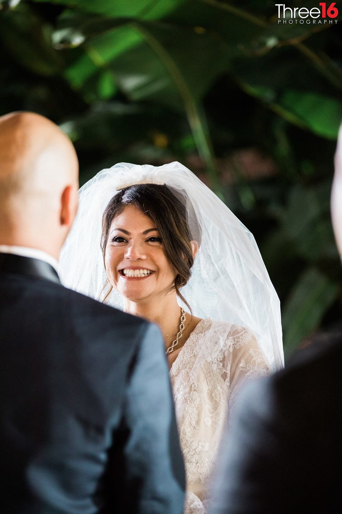 Bride smiles big at her Groom at the altar