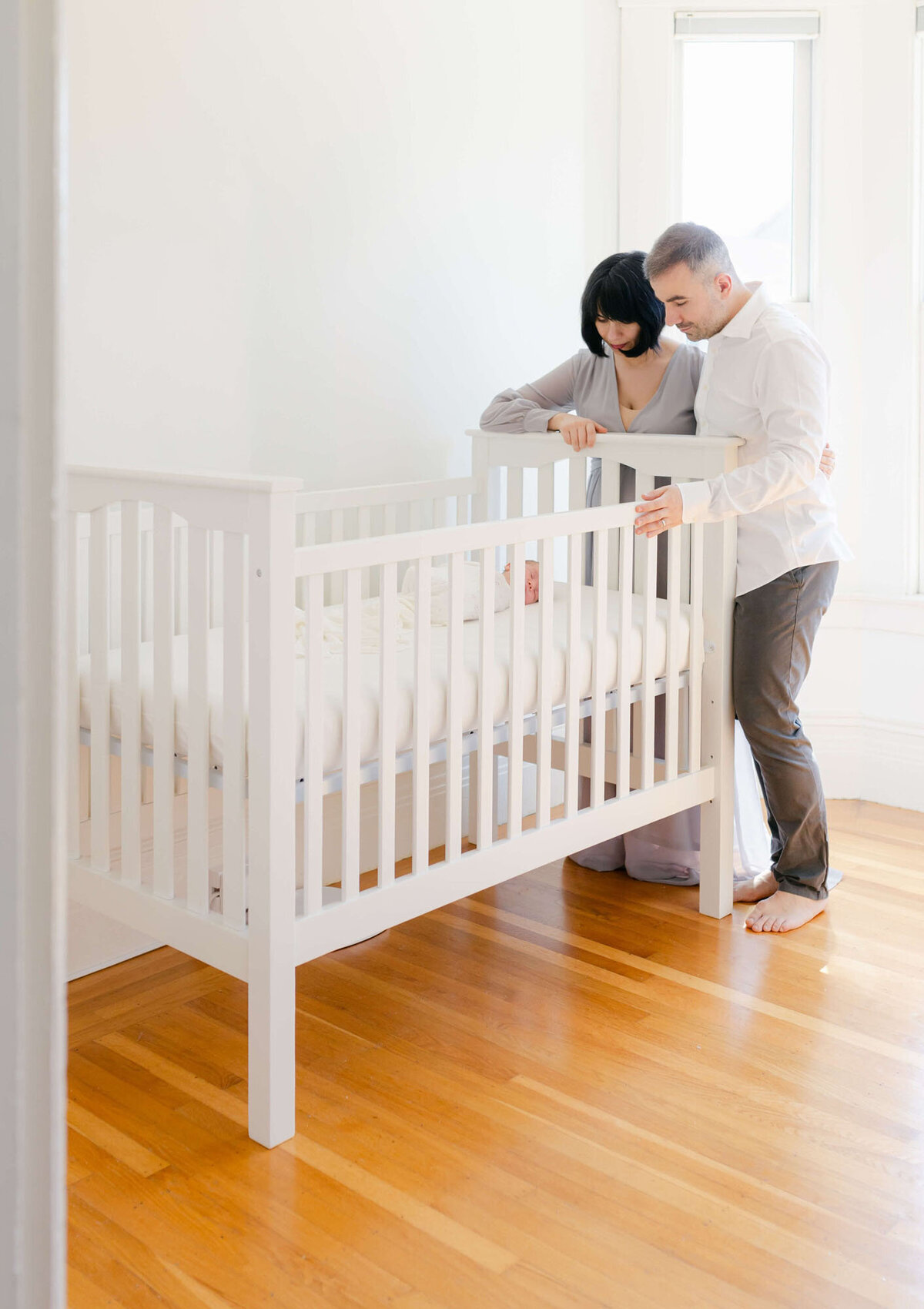 Lifestyle Bay Area newborn family photography in nursery with parents and baby.