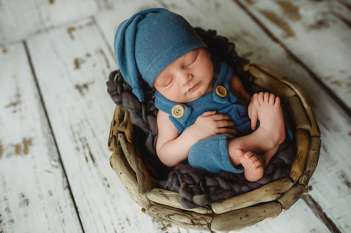 Charleston, SC #1 Newborn Photographer poses infant for Newborn Photoshoot in Charleston Portrait Studio.