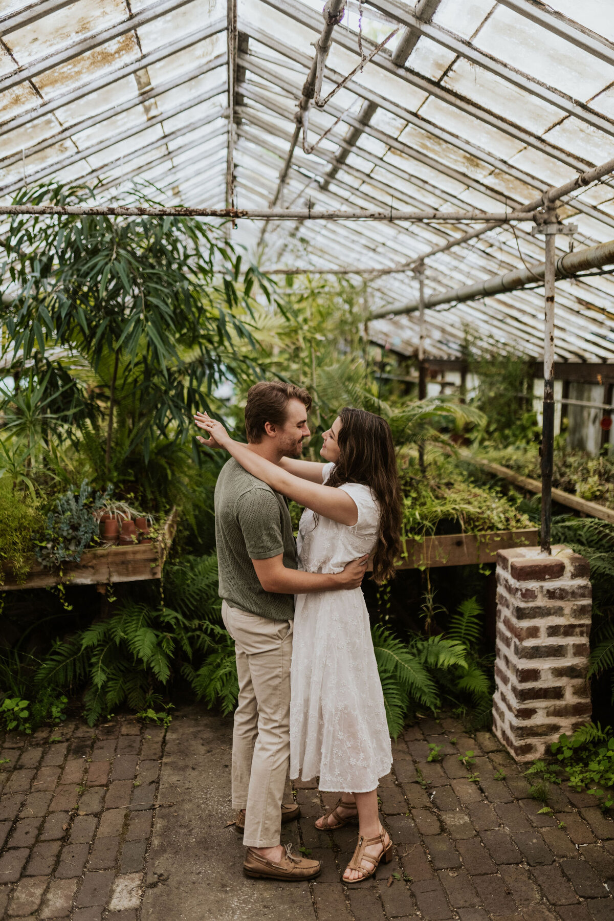 a couple embracing inside a greenhouse