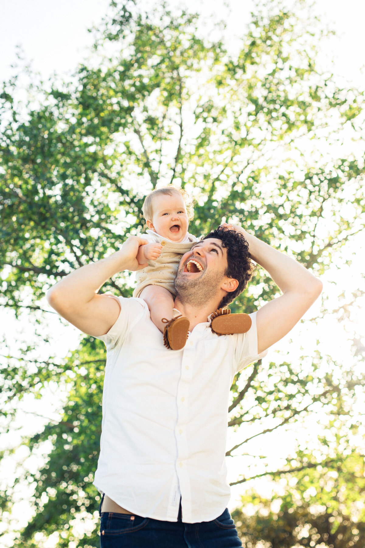 Family Portrait Photo Of Baby In Light Brown Jumper Riding Her Father's Shoulder Los Angeles