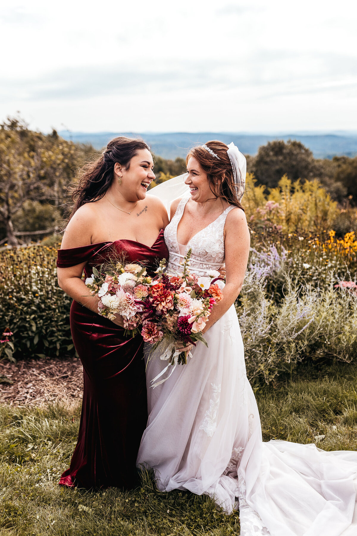 Joyful moment between bride and her maid of honor in garden at Cobb Hill Estate in NH by Lisa Smith Photography