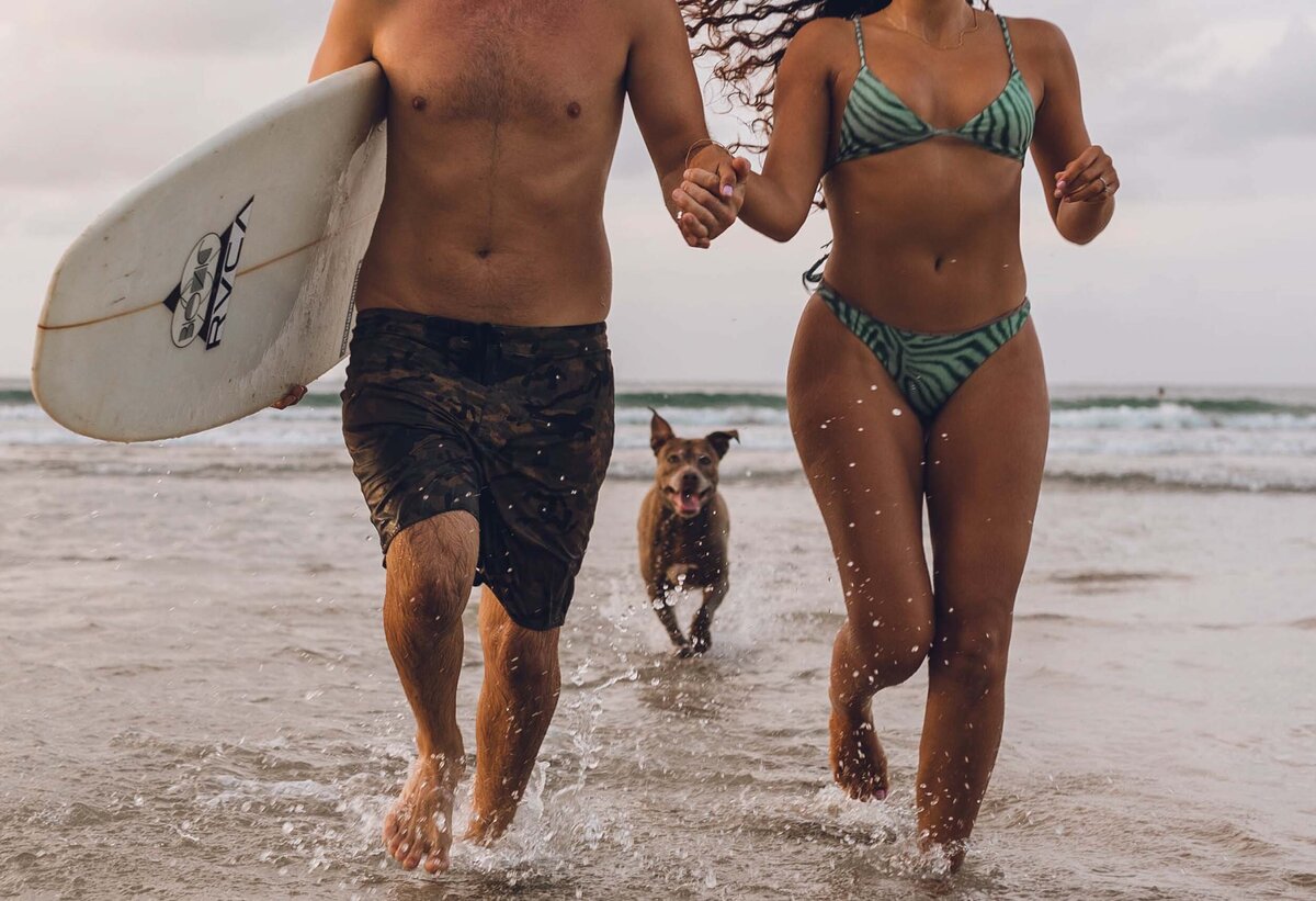 Couple running down the beach