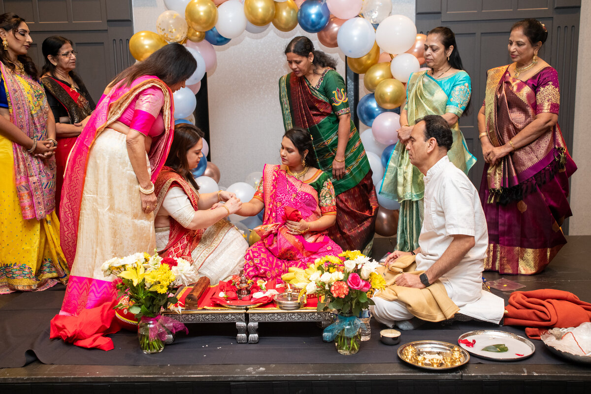 traditional indian baby shower ceremony with smiling happy people